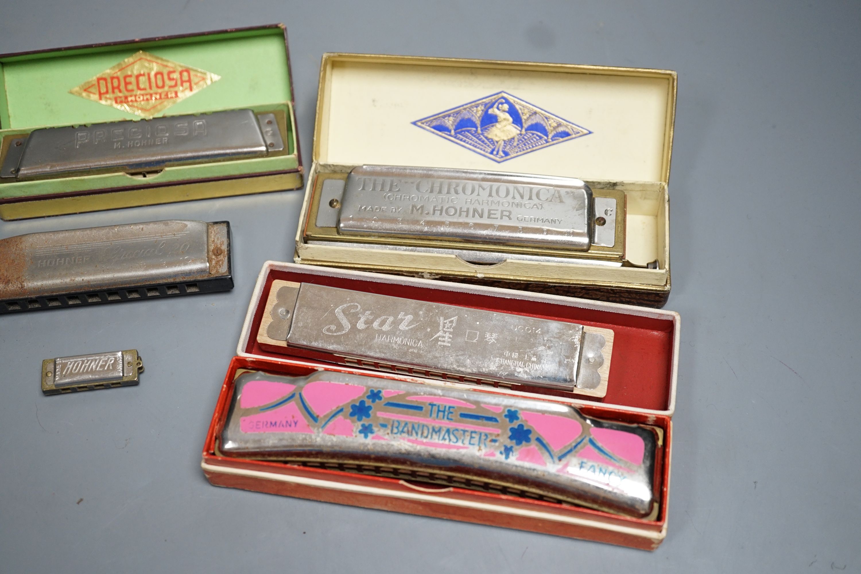 Eight various harmonicas, some with boxes